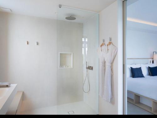 a bathroom with a shower and a robe hanging on a wall at Villa Laeti in Saint-Jean