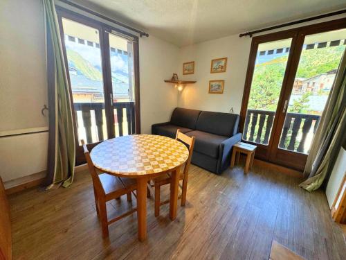 a living room with a table and a couch at Résidence Biolley 1 - Studio pour 2 personnes dans le centre du village MAE-4274 in Saint-Martin-de-Belleville