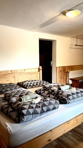a large bed in a room with at Penzion Pod Lípou in Dolní Brusnice