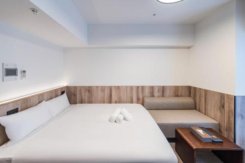 Ένα ή περισσότερα κρεβάτια σε δωμάτιο στο Apartment Hotel 11 Nagoya Sakae