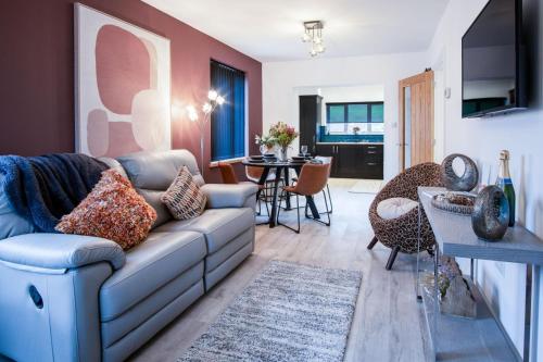 a living room with a couch and a dining room at Wiston Street - 2 Bedroom Holiday Home - Pembroke in Pembroke