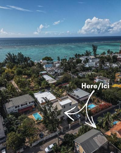 an aerial view of a city with the ocean at Searenity Villas in Rivière Noire