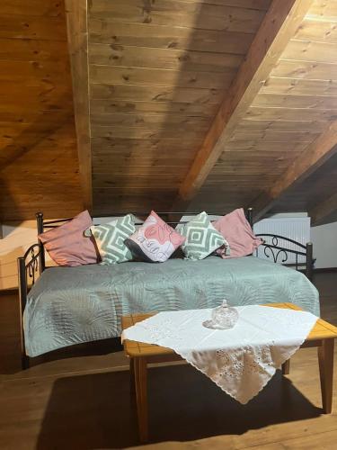 a bed with pillows and a table in a room at The stone Mansion of 1887 