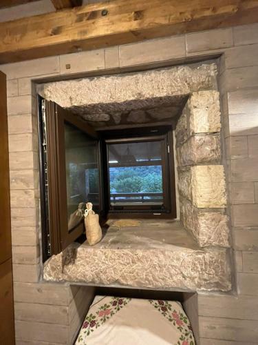 a window in a room with a stone wall at The stone Mansion of 1887 