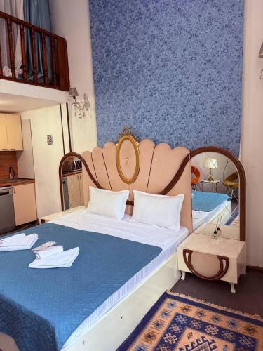 a bedroom with a large bed with a head board at Boutique Hotel Gold Tbilisi in Tbilisi City