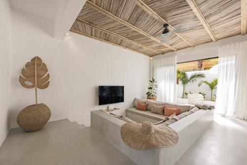 a living room with a couch and a tv at Searenity Villas in Rivière Noire