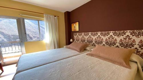 a bedroom with a large bed and a window at Gran Rey n4 in Valle Gran Rey