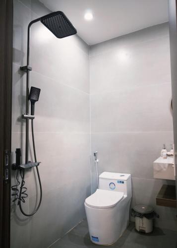 a bathroom with a white toilet and a shower at Joie Homestay Huế in Thôn Trường Giang