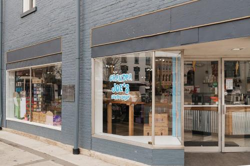 a store front of a store with a sign in the window at The Cozy Corner - Downtown Troy in Troy