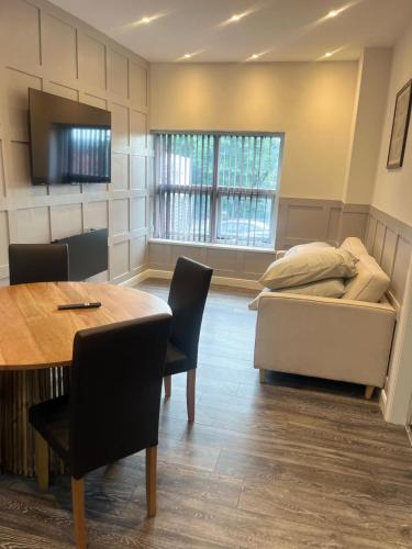 Un dormitorio con una cama y una mesa y sillas. en 2 Bedroom Property at sovereign House, en Keighley