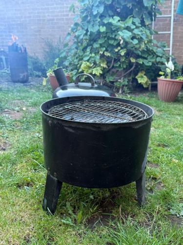 a black grill sitting in the grass in a yard at Studio- Sleeps 2- Free WiFi- Luxury Shower in Birmingham