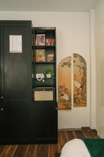 a room with a black cabinet and a mirror at Chez Lumi Hotel in Hanoi