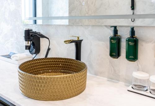 a bathroom sink with a faucet and a basket sink at Elania Resort & Spa in Cluj-Napoca