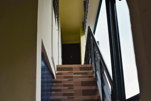 a staircase in a building with black and brown steps at Point Vista Transient Accomodation in Daet
