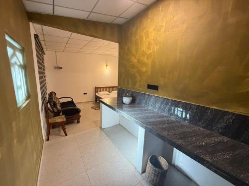 a room with a long counter in a room at Ceylonia Ape Gedara in Kochchikade
