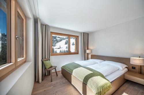 a bedroom with a large bed and a window at Turrabuel in Parpan