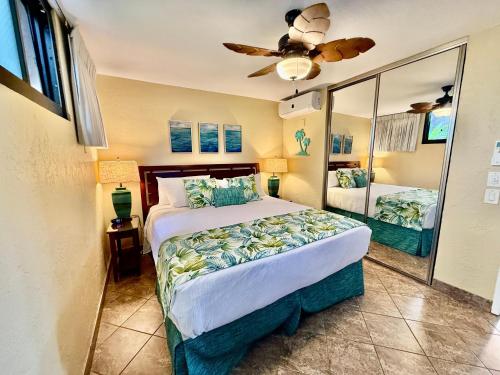 a bedroom with a bed and a ceiling fan at Papakea L101 · PK L101 Maui Ground-Floor Condo with Ocean Views in Honokowai