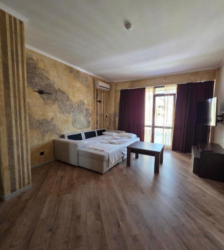 a bedroom with a bed and a table in it at Art Hotel Babylon in Sunny Beach