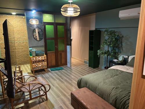 a bedroom with a bed and a chair and a door at The oasis on 8 Tropical 2 