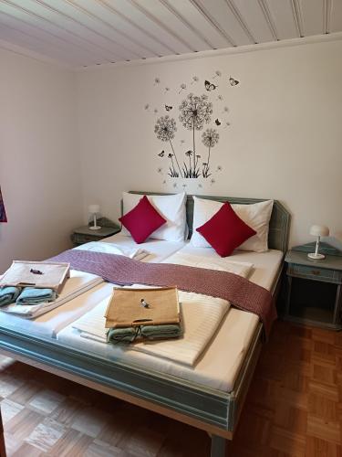 a bedroom with a large bed with red pillows at Haus Bernkogel in Sankt Johann im Pongau