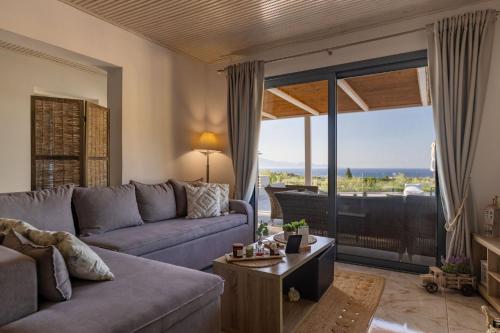 a living room with a couch and a table at Villa Venia - Cozy Escape with Scenic Sew View, by ZanteWize in Tragaki