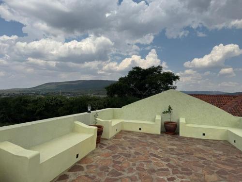 a balcony of a house with a view at Tano Bora Villa in Sekenani
