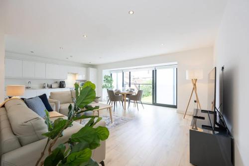 a living room with a couch and a table at Brooklyn Mews-Free Parking-Village Location in Cheadle