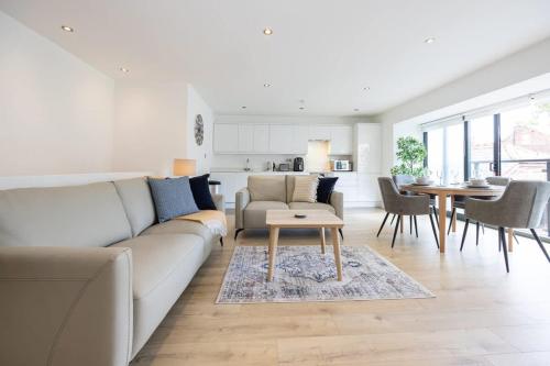 a living room with a couch and a table at Brooklyn Mews-Free Parking-Village Location in Cheadle