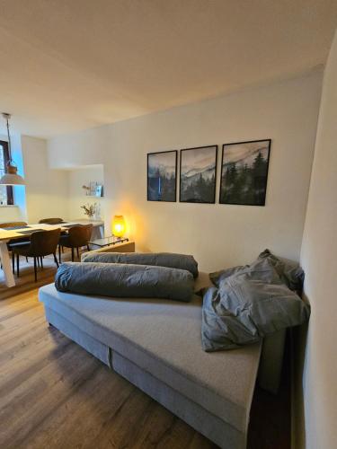 a bedroom with two beds and a dining room at Altes Pfarrhaus Amorbach in Amorbach