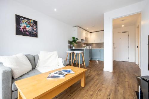 a living room with a couch and a table at The Withington loft- Close To Uni's & Hospitals in Manchester