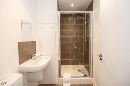 a bathroom with a shower and a toilet and a sink at The Withington loft- Close To Uni's & Hospitals in Manchester