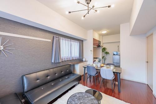 a living room with a couch and a table at Flowing home in Nagoya