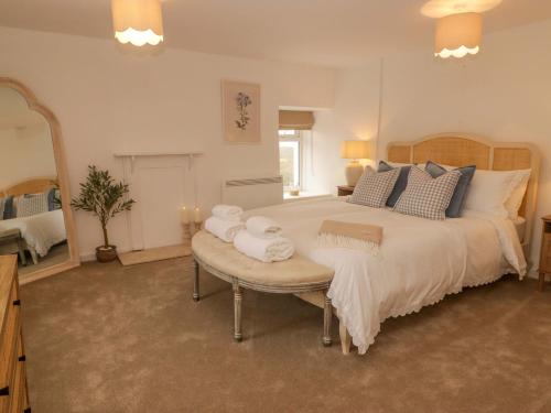 a bedroom with a large bed and a large mirror at Pentwyn in Solva