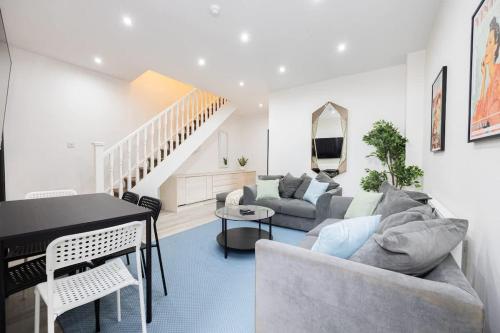 a living room with a couch and a table at The Didsbury Loft in Manchester