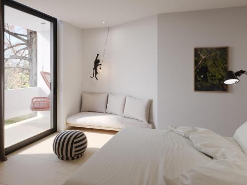 a white bedroom with a bed and a couch at Du Lac Et Du Parc Grand Resort in Riva del Garda