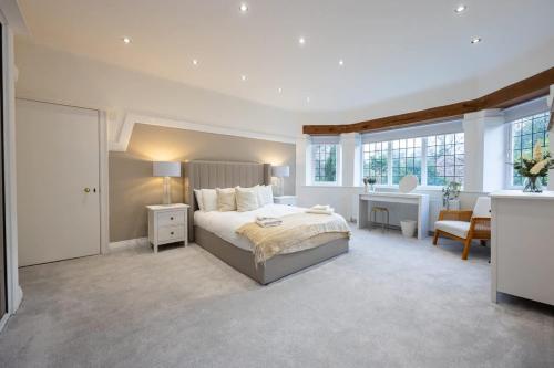 a bedroom with a bed and a desk in a room at The Coach House - Grade 2 Listed in Hale