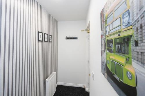 a hallway with a mural of a bus on the wall at SandyCroft- Secure gated Parking & Close To Airport in Wythenshawe