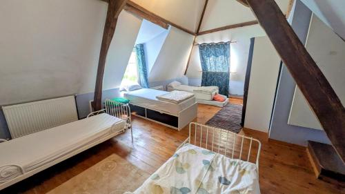 a living room with two beds and a couch at House - comfortable - spacious - 15' from Lille in Leers