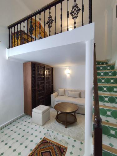 a living room with a couch and a staircase at AMY Brothers Apartments in Tangier