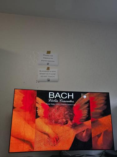 a poster of a woman with wings on a wall at Room for 4 People with Garden View in Kirchheim