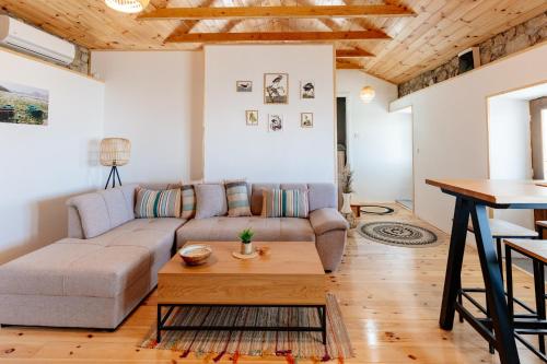 a living room with a couch and a table at Pelican Bay House - Skadar Lake in Krnjice