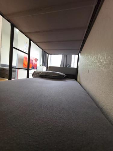 a large bed in a room with windows at Room for 4 People with Garden View in Kirchheim