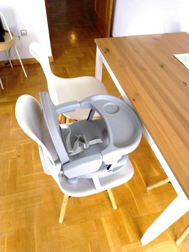 a white high chair sitting next to a table at LLanes Vistas increíbles A 7 min a pie del centro in Llanes