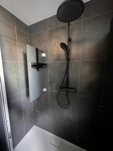 a shower with a shower head in a bathroom at STAYtion Ferienhaus Balingen in Balingen