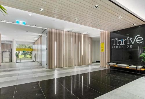 a lobby of a building with a sign on the wall at ADEK Apartments North Melb - 2BR Apt near Melb Zoo with free Parking, Pool & Gym in Melbourne