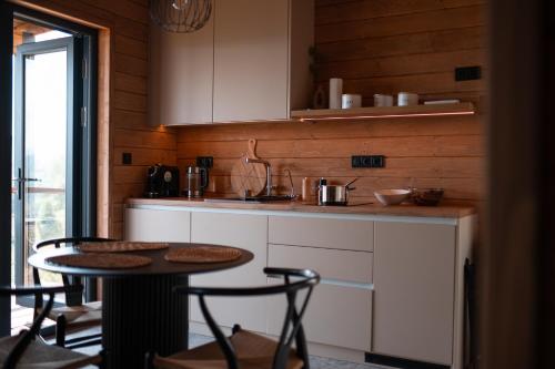 a kitchen with a table and two chairs and a counter at Shepit space in Slavske