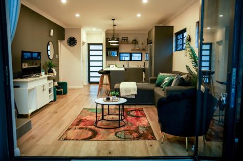 una sala de estar con un sofá y una mesa en M-Stay on Baywest, en Gqeberha