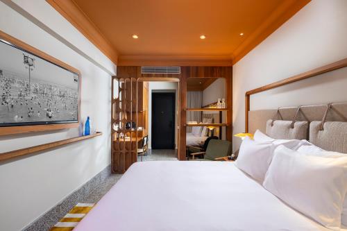 a hotel room with a bed and a desk at Hotel 1935- By Adam Hotels in Tel Aviv