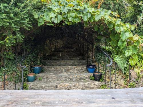 a stone stairway with a bunch of plants on it at A Characterful Cotswolds Mill in Moreton in Marsh