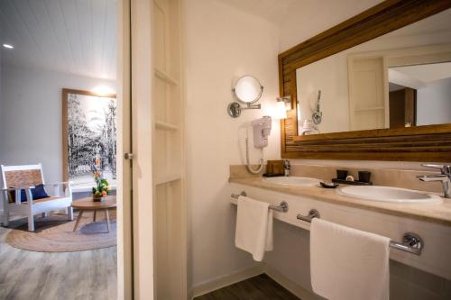a bathroom with a sink and a mirror at Canonnier Beachcomber Golf Resort & Spa in Pointe aux Cannoniers